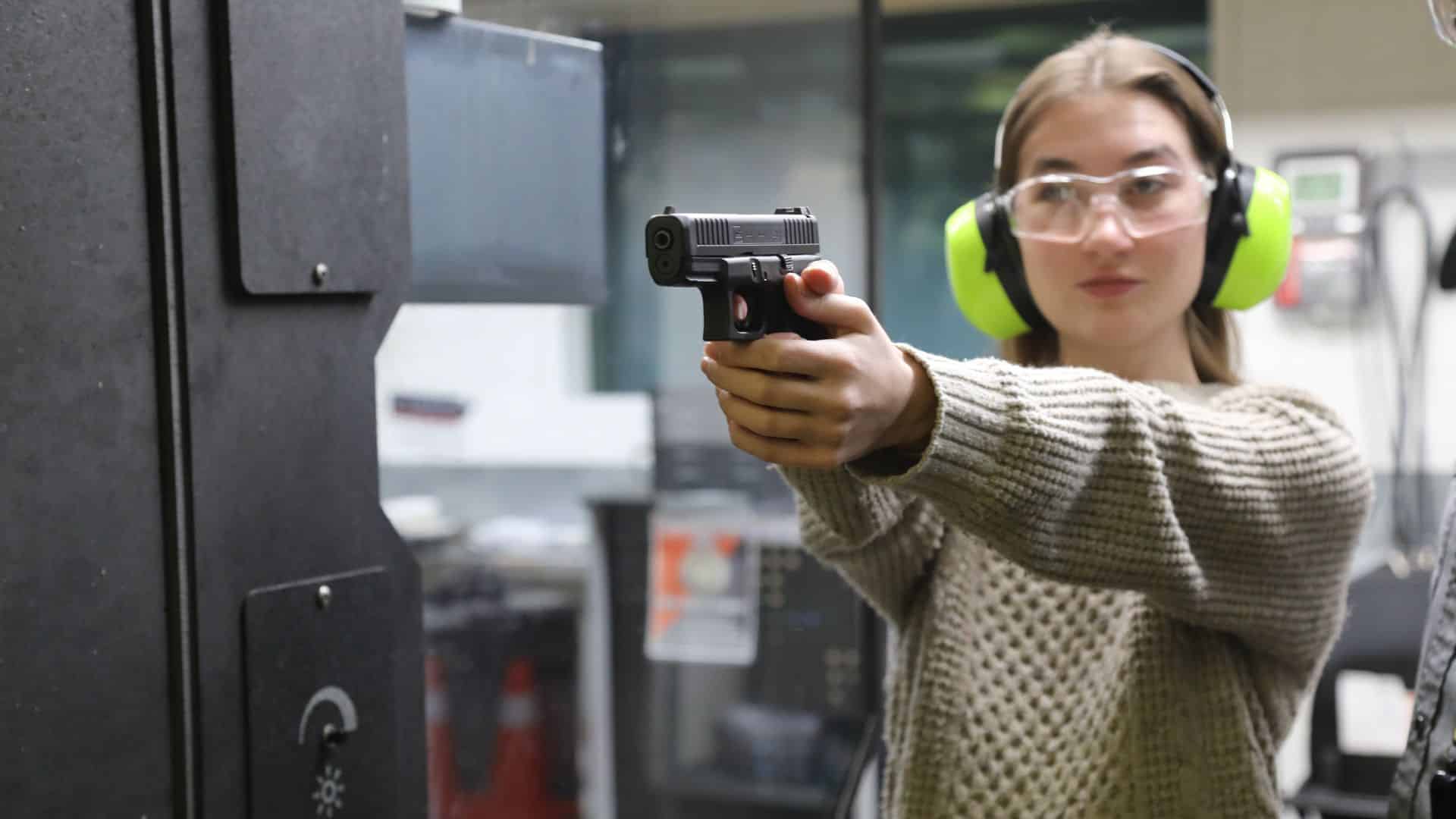 A man shooting a machine gun at CGC